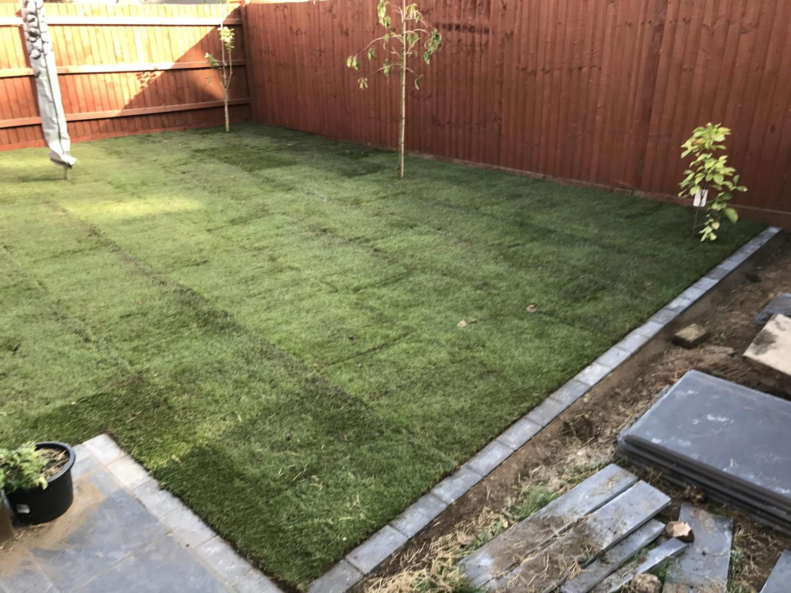 This is a newly turfed garden with a grey brick border.
